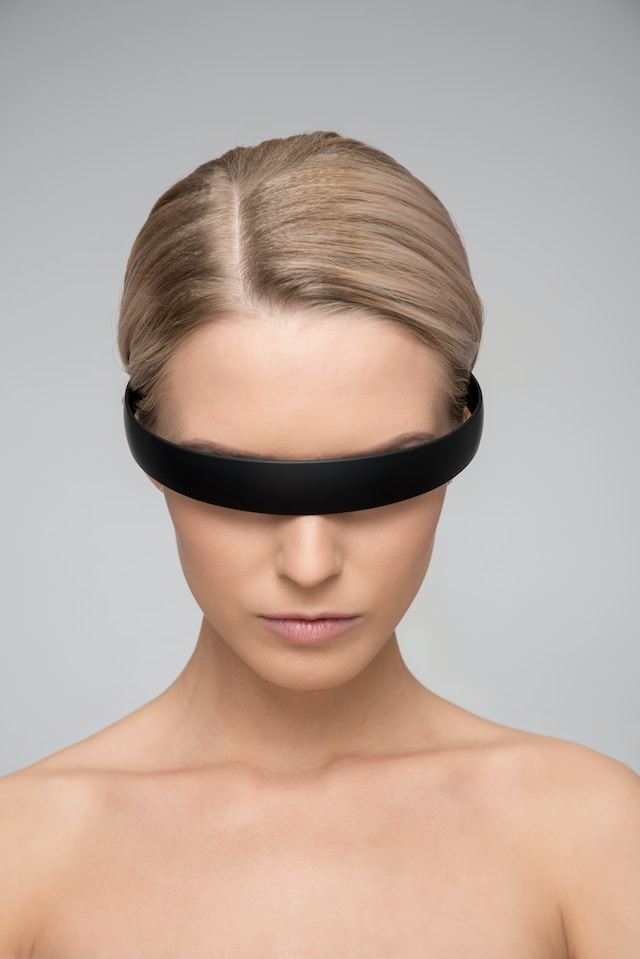 Woman wearing futuristic, facial recognition eyewear.