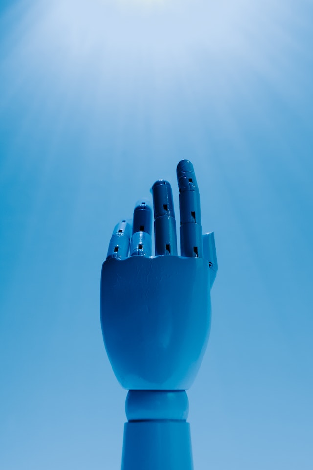 A robot's hand reaching upward.