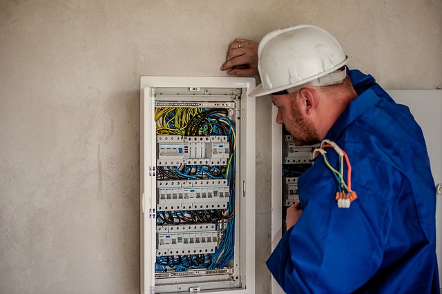 An electrician checking out an electric panel