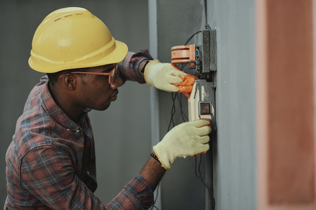 An electrician checking the wiring at a property