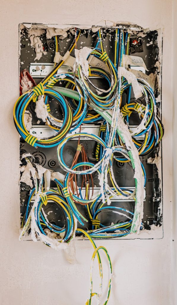 An electrical panel with an assortment of coiled cables