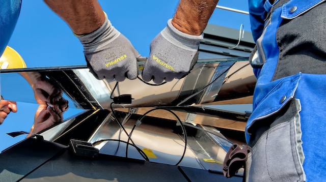 A [air of hands installing solar panels