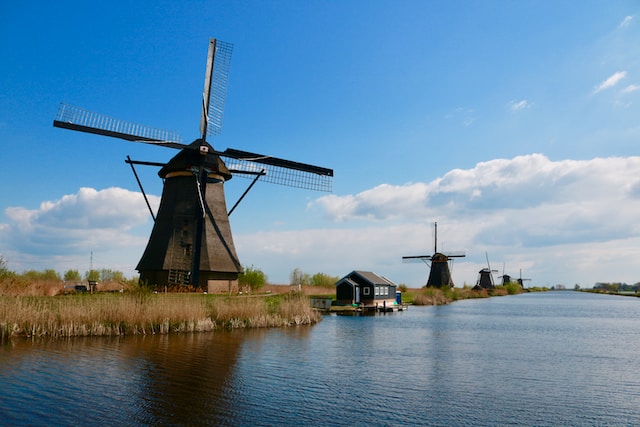 Windmills beside a river
