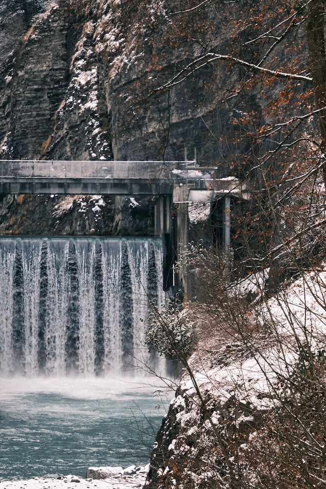 Clear water flows through a dam and into a river