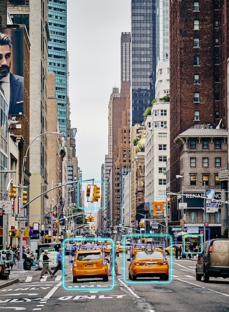 Cars and people on a busy city street