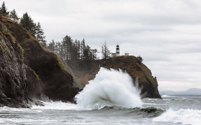 Strong waves crash against a hillside