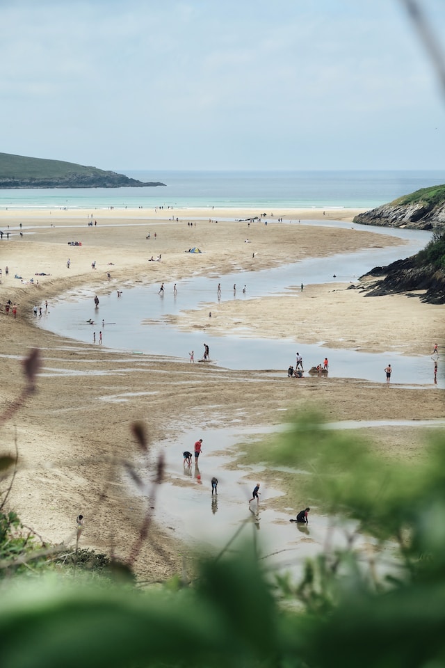 People o n the shore where water has receded during low tide