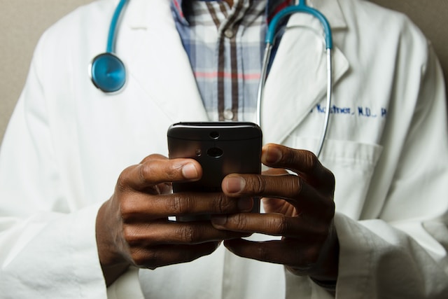 A doctor holding a smartphone
