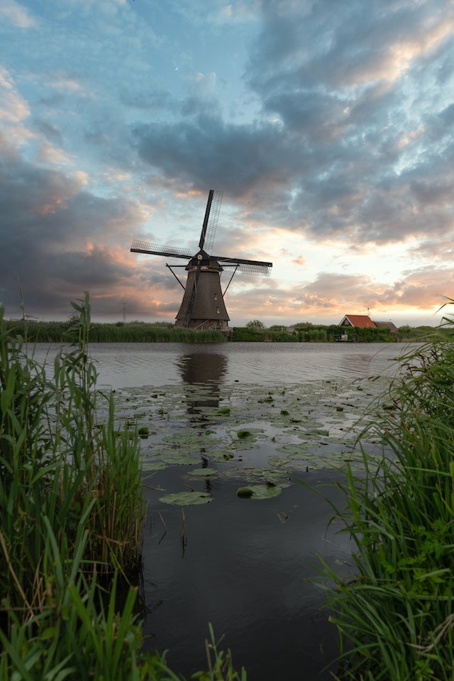 Rustic-looking windmill near a river