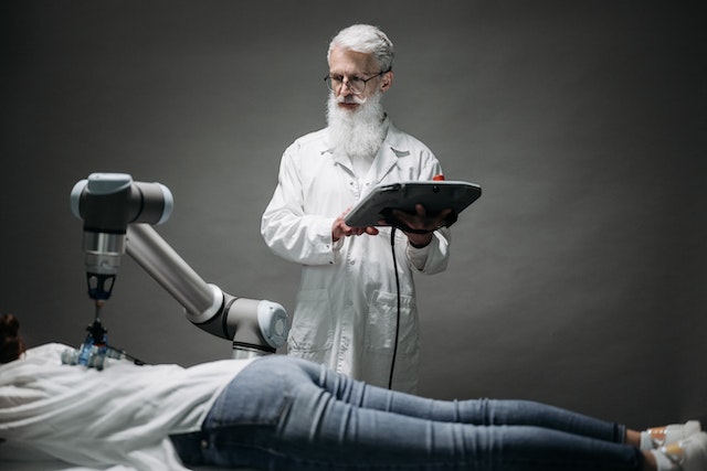 Scientist testing a robotic massaging arm 