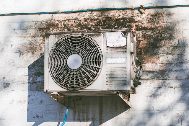 An air conditioning unit on a concrete wall