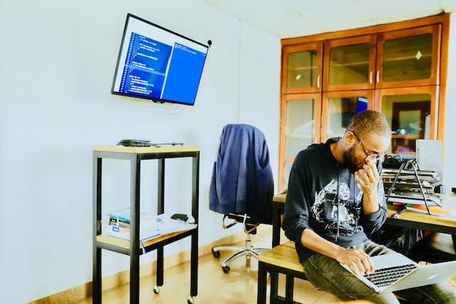 Person intently looking at something he's working on his laptop