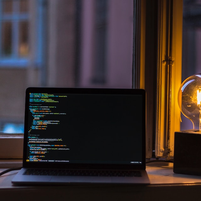 Black laptop with code on the screen