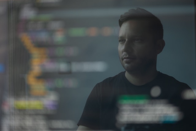 Person stares at a screen of blurred computer codes