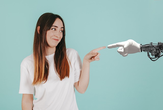 Woman about to touch a robotic hand