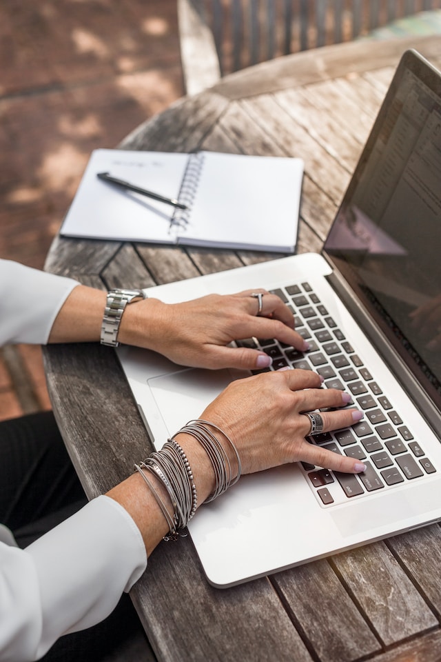 Person typing on laptop keyboard