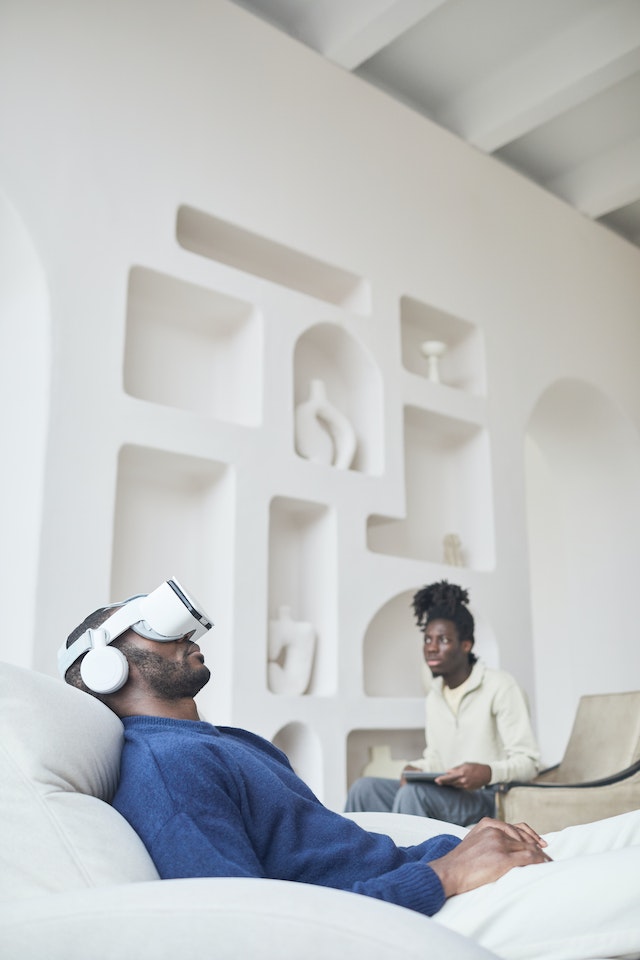 Person wearing a VR headset while lying in bed