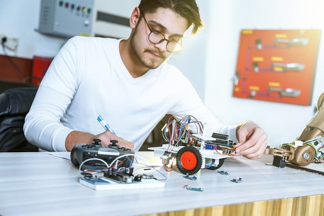 Person fixing an electronic component on a table